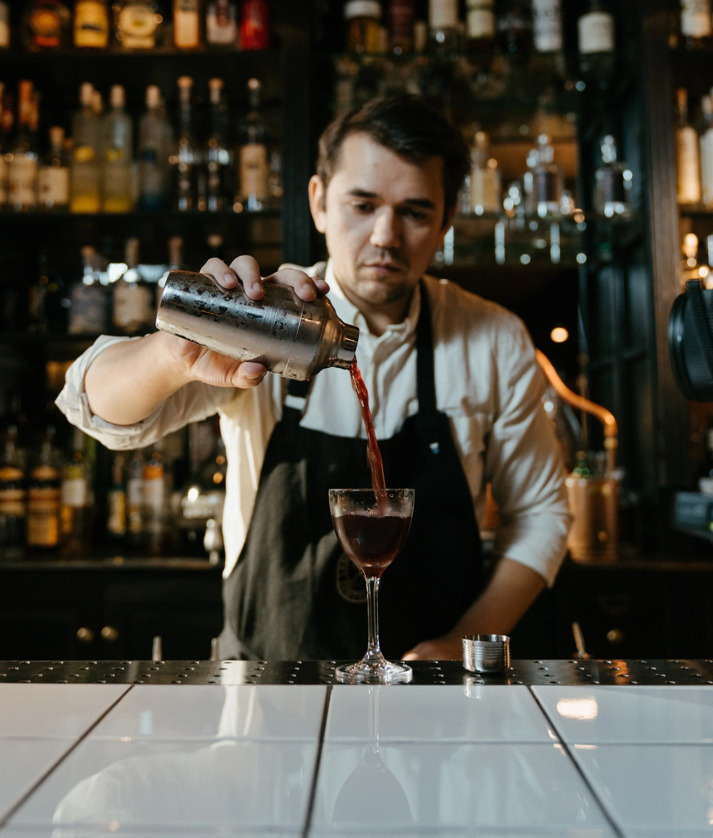 Bartender measuring a pour