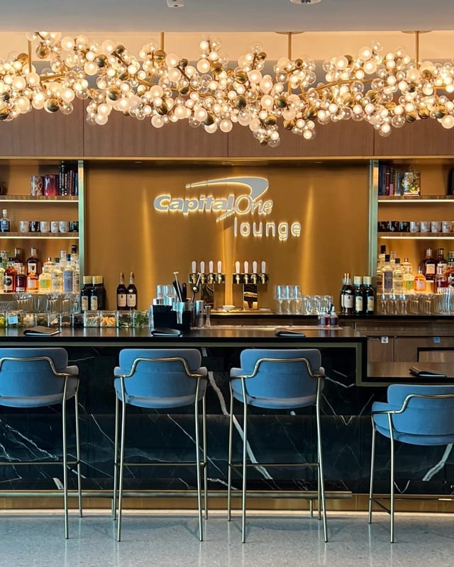Bar and Capital One Lounge sign under the chandelier